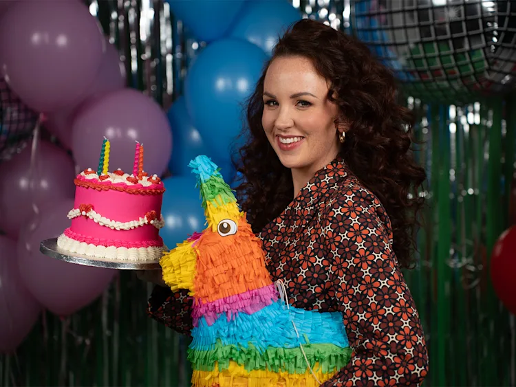 Catherine Bohart holding a cake
