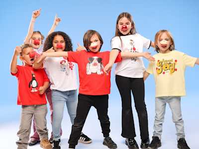 A group of school children wearing red noses