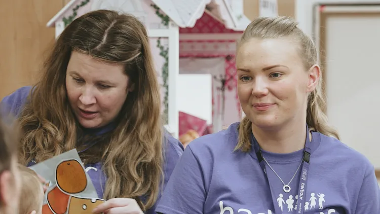 Two Harbour staff members conduct a group activity.