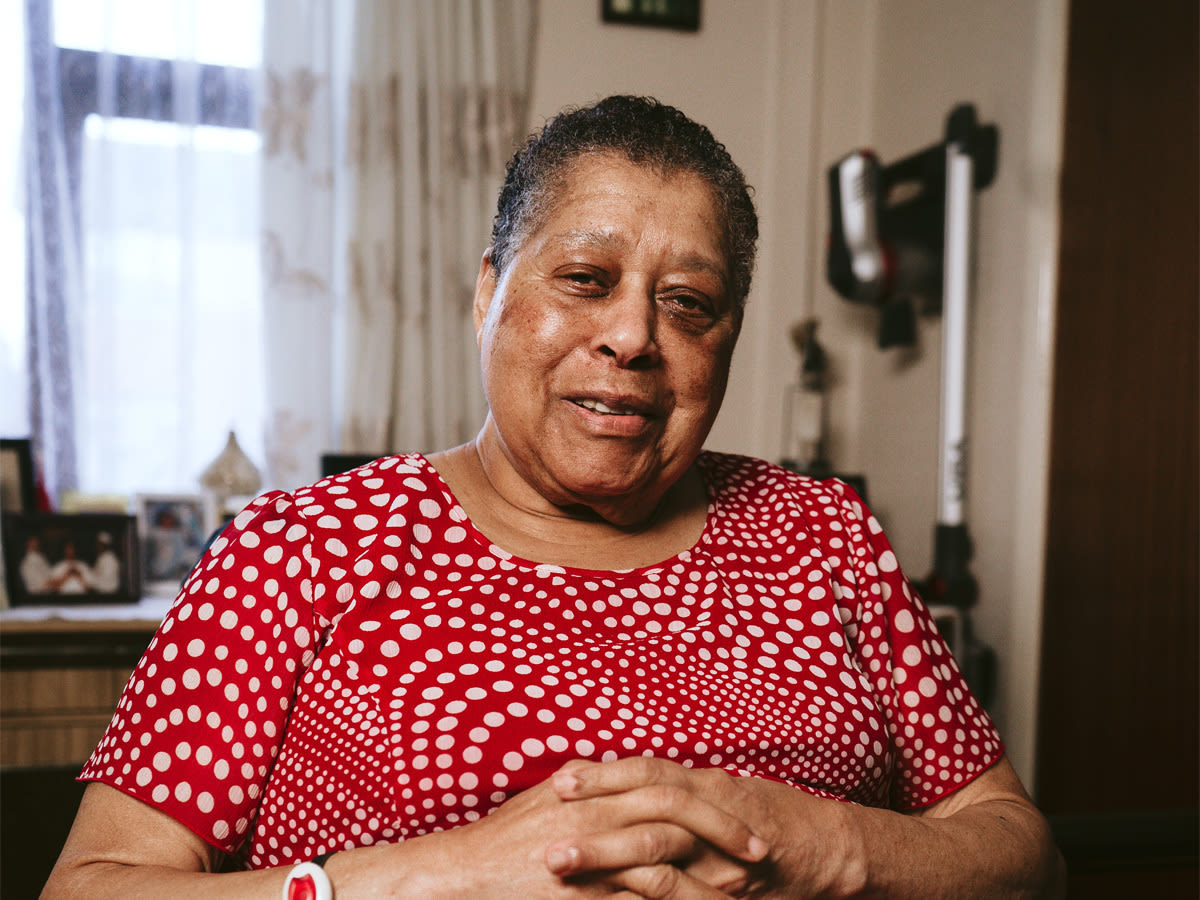 Yvonne sits in her lounge. She started visiting the African Caribbean Care Group (ACCG) twice a week. The ACCG is a lively and friendly daycare service for older members of the community – including those with long term health conditions, disabilities and mental health problems.