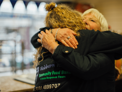 Hebburn helps cofounder Angie Comerford embraces an older woman.