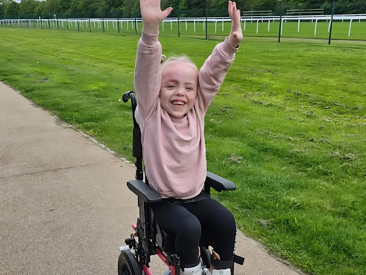 A child with her hands raised