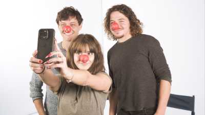 The cast of Outnumbered smiles while taking a selfie, each wearing a red nose.