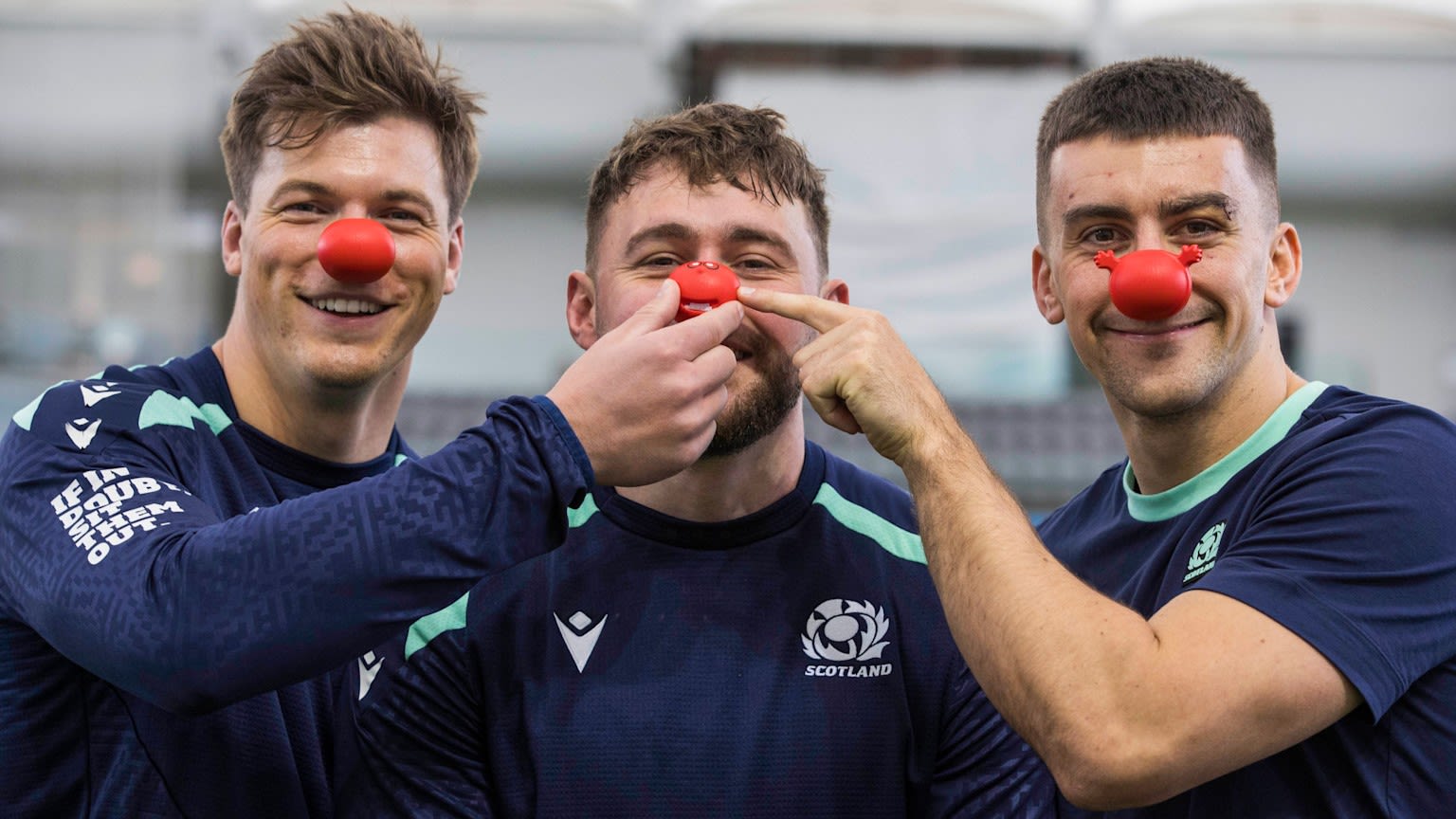 Rugby team players wearing red noses
