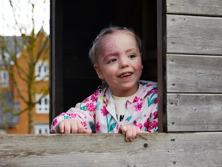 A little girl looking out of a window