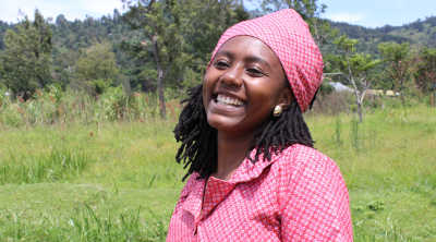 A woman in field wearing pink