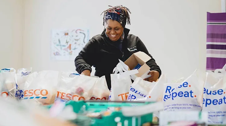 Tracey with bags of food.