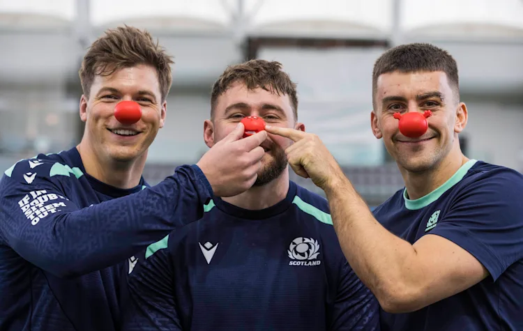 Players of the Scotland Rugby team wearing red noses