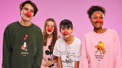 Four secondary school children wearing red noses smiling at the camera