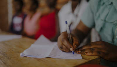 Student writing on a notepad