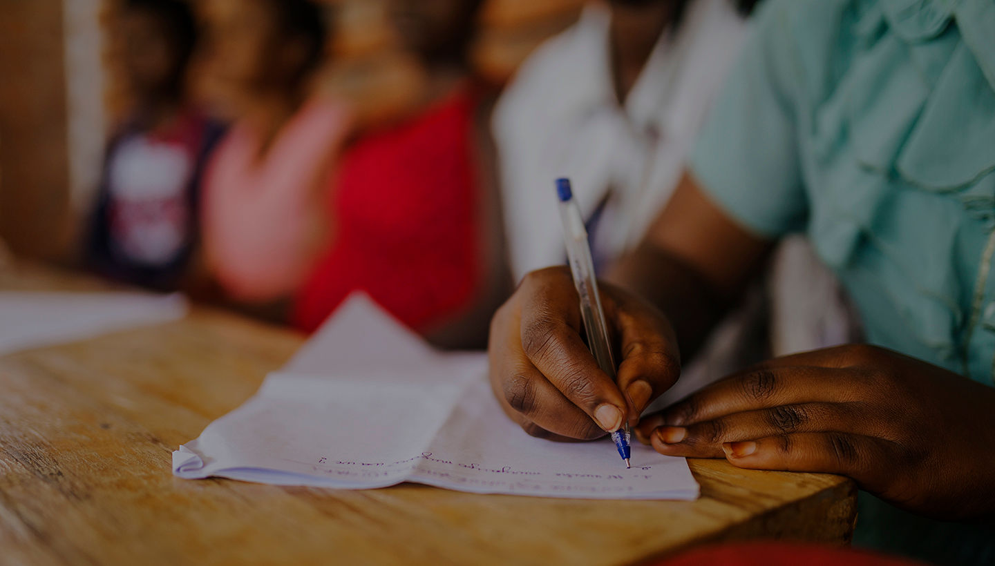 Student writing on a notepad