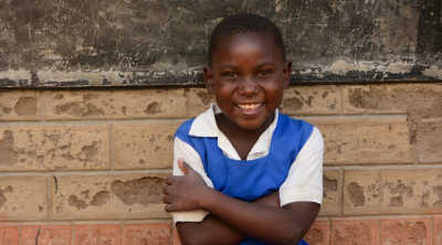 Child poses smiling for the camera