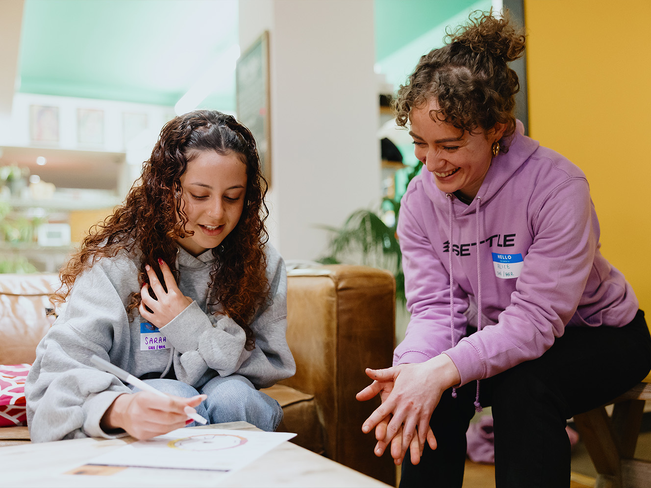Sarah and her coach Alice at Settle talking and smiling