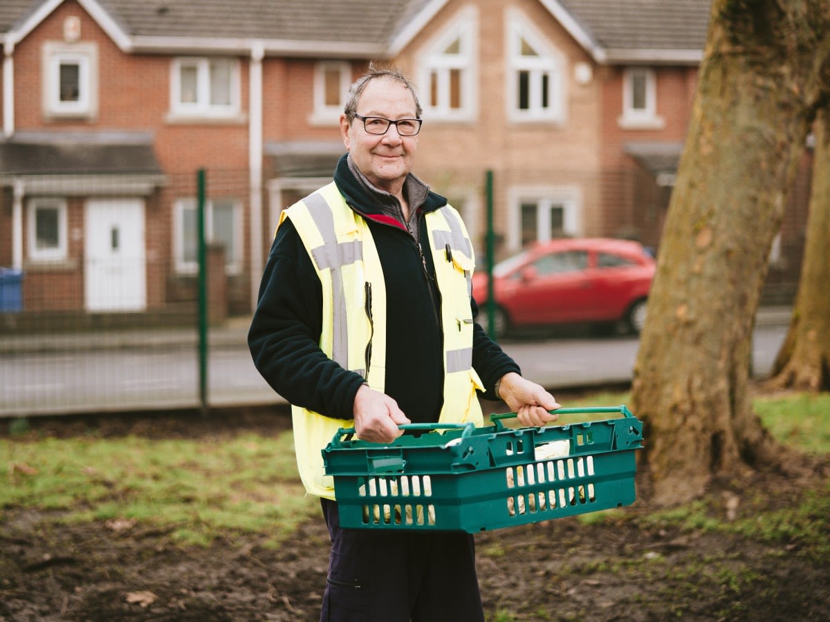 A volunteer at the African Caribbean Care Centre makes a food delivery.