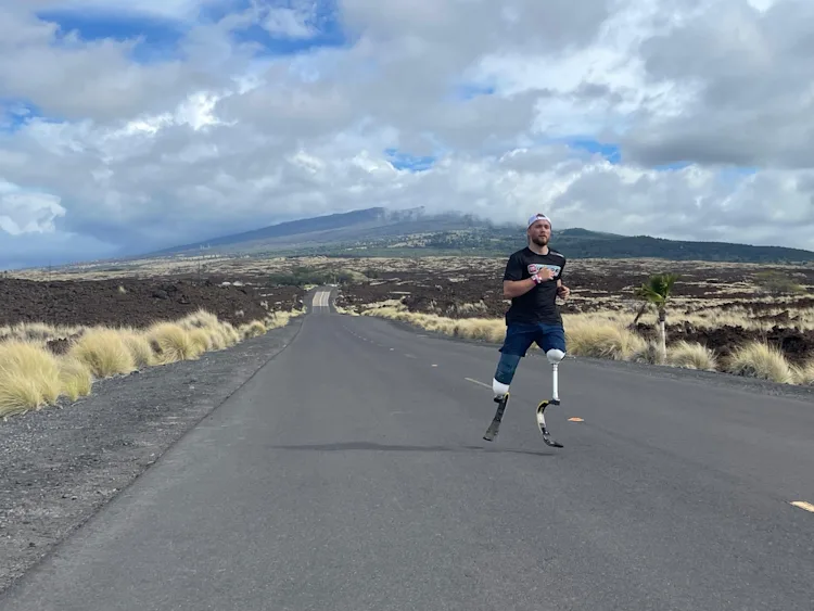 Billy Monger running on an empty road