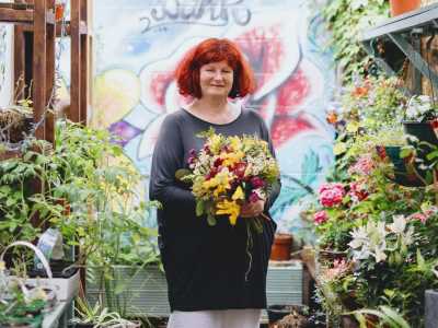 Ursula holding a bouquet of flowers. Ursula is the project leader at the Flower Bank in London, an award-winning, zero-waste social enterprise that wants to change the community for the better.
