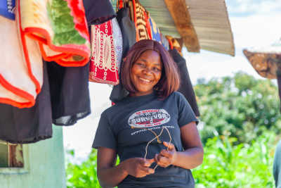 Woman smiling in front of market stall