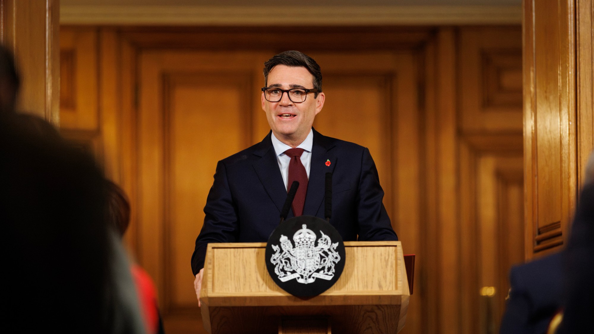 Prime Minister Andy Burnham speaking at a lectern at the No.10 Downing Street Rough Sleeping Summit