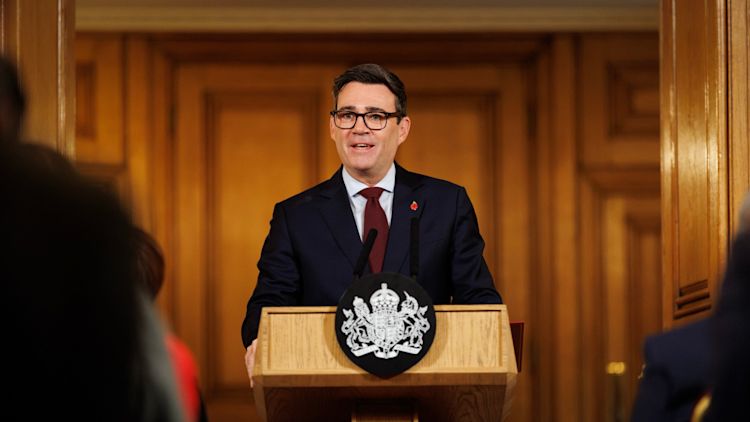 Prime Minister Andy Burnham speaking at a lectern at the No.10 Downing Street Rough Sleeping Summit