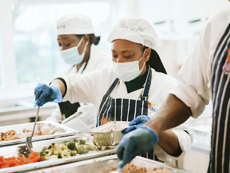 Chefs at the African Caribbean Care Centre prepare meals.