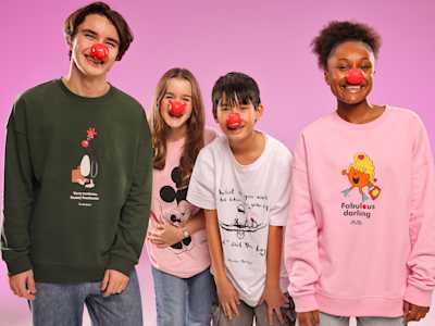 Four secondary school children wearing red noses smiling at the camera