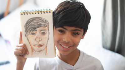 Farhad showing a drawing of him