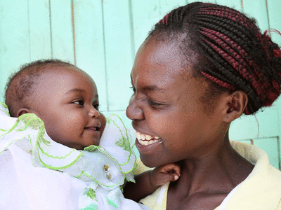 A woman smiling at her child
