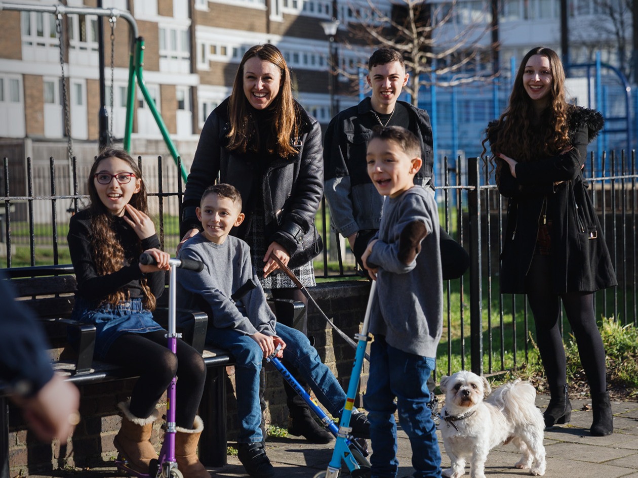 A family standing outside their flat