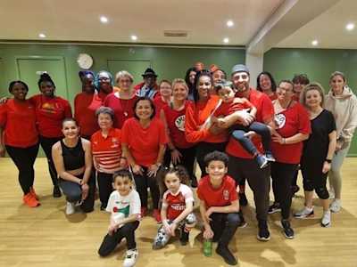 A group of children and adults wearing red t-shirts 