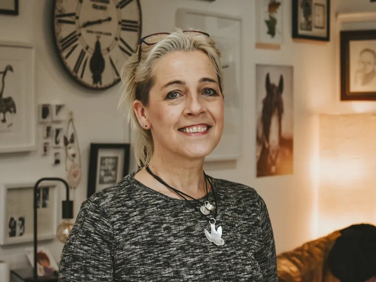 Kate smiles at the camera from her lounge.