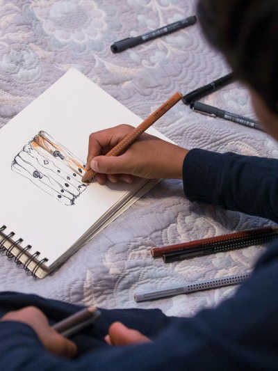 Farhad drawing in his sketchbook