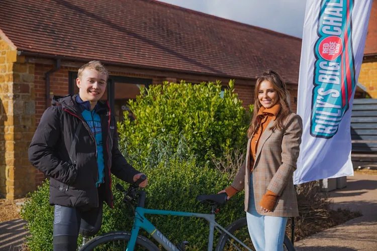 Cheryl (R) surprised Billy Monger for the third stretch of his exhausting triathlon inspired challenge today, to offer her support in his bid to raise life changing cash for Red Nose Day.
