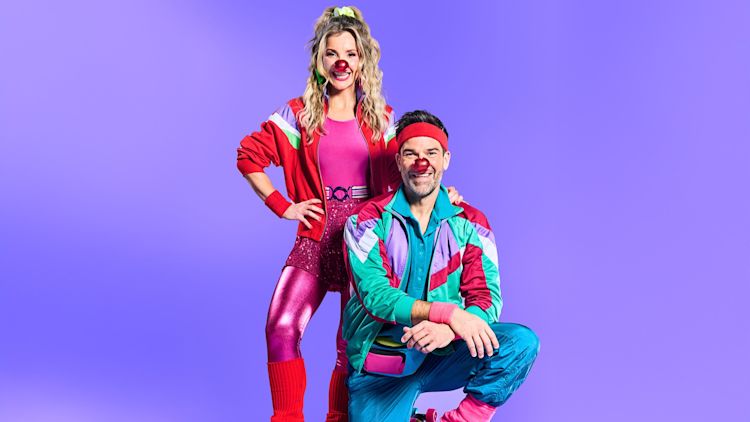 Gethin and Helen wearing retro roller skating clothes and red noses posing for the camera