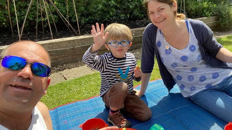 Arlo and his parents outside.
