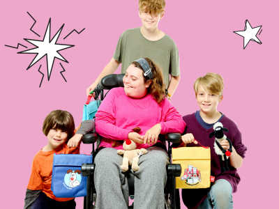 A group of children pose with Wallace and Grommet Red Nose Day merchandise. Her three brothers pose with her, one behind. 