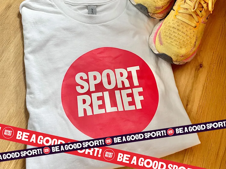 A folded white t-shirt with the sport relief logo and a pair of yellow trainers