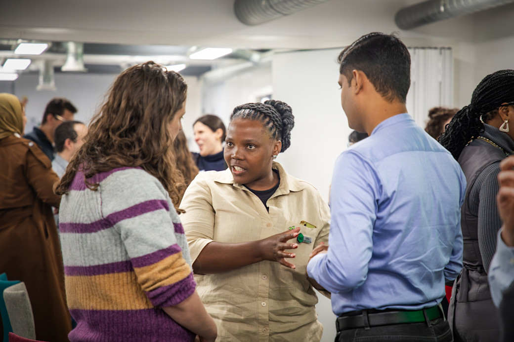 Three people in conversation during the Global Clubs Partnership meet up 