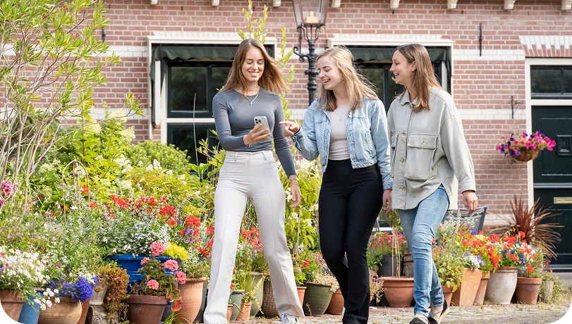 3 dames met een mobiele telefoon
