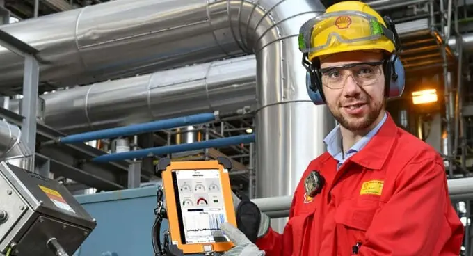 Shell medewerker staat in fabriek met een meter in zijn 