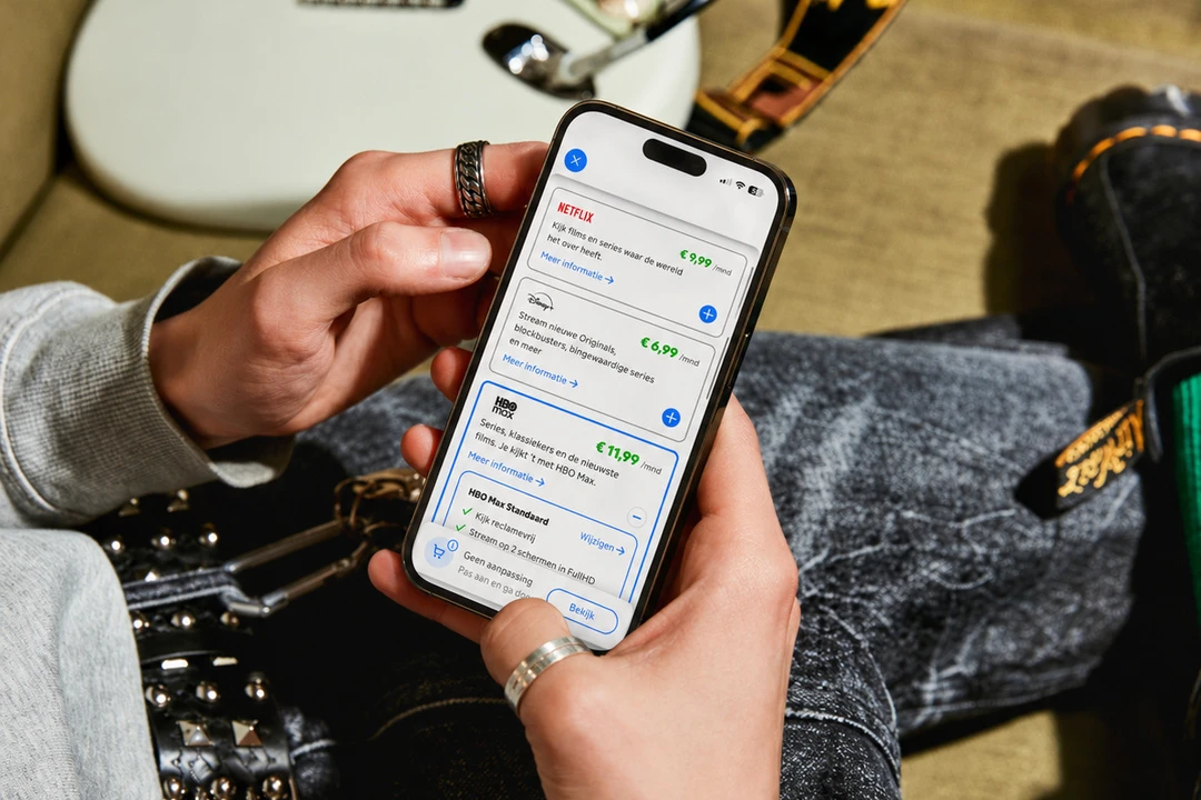 Hand met mobiel in MijnKPN om entertainment te wijzigen