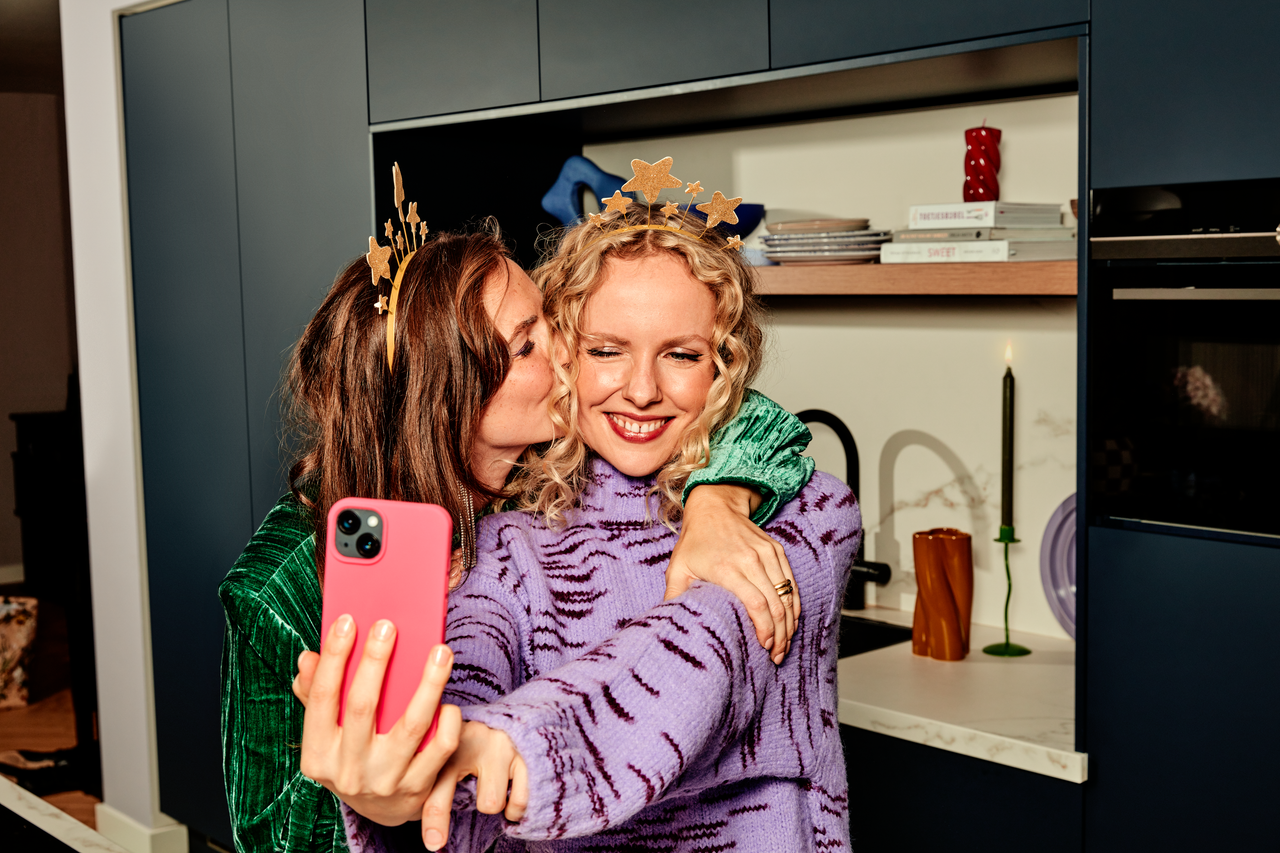 Twee vrouwen maken een selfie en knuffelen
