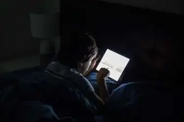 iemand zit in donker op een laptop te kijken