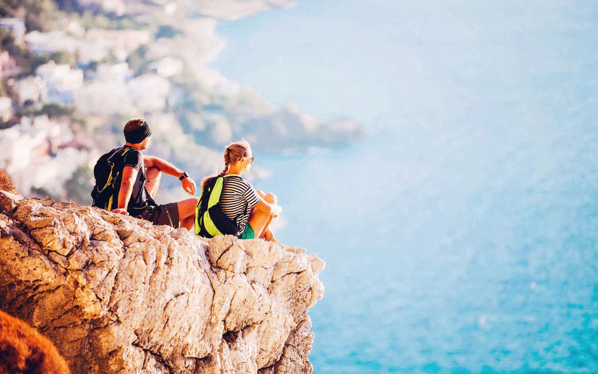 two guys on a cliff by the sea