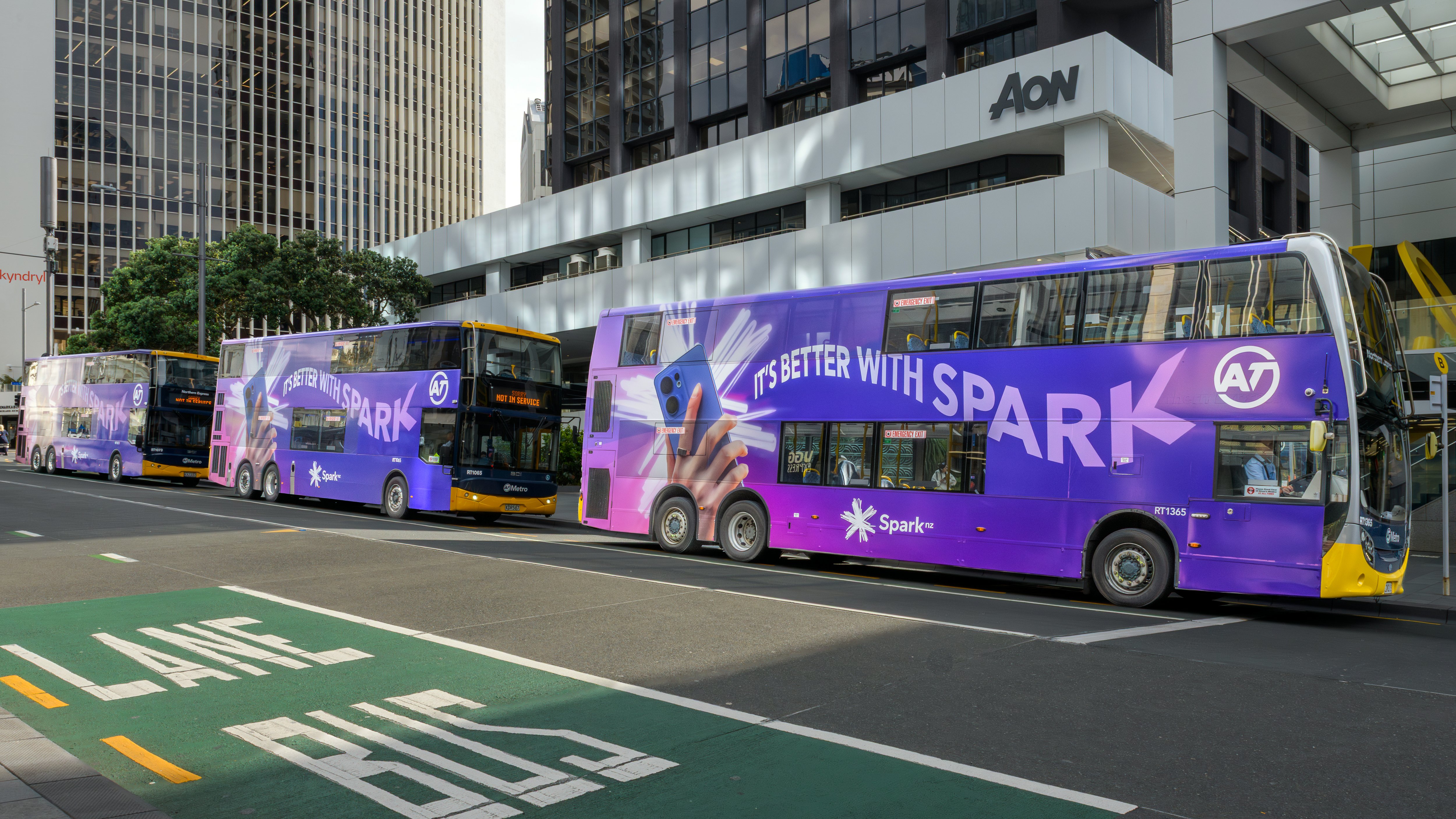 Three Spark 'It's better with Spark' campaign double decker buses on Auckland's Lower Albert Street. 