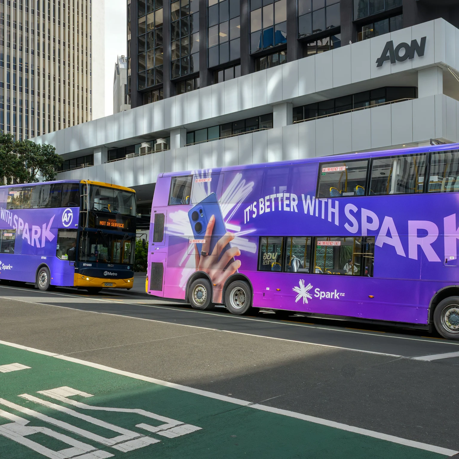 Three Spark 'It's better with Spark' campaign double decker buses on Auckland's Lower Albert Street.