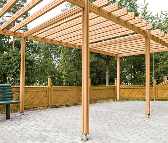 A spacious pergola creates a leafy room when used with green climbing plants.