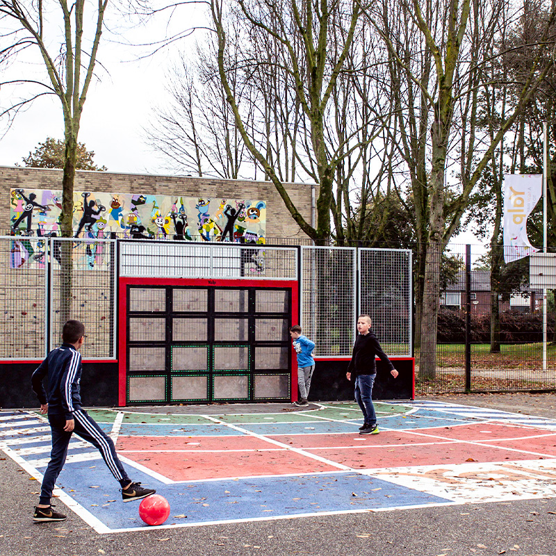 Boys playing the game Shape on the Lappset Sutu Interactive ball wall