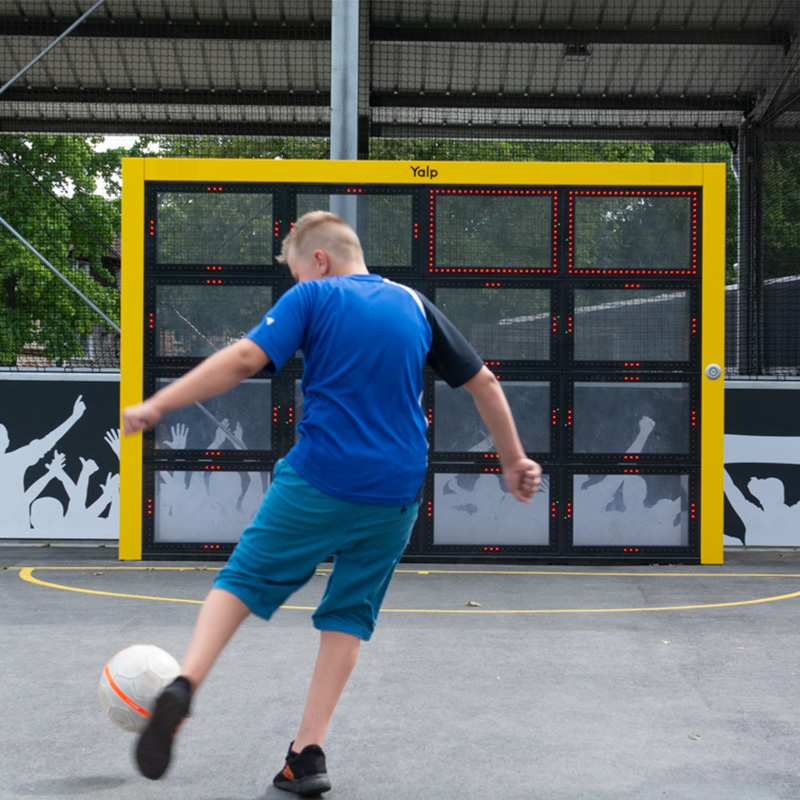 Boy playing football on the Sutu Interactive ball wall