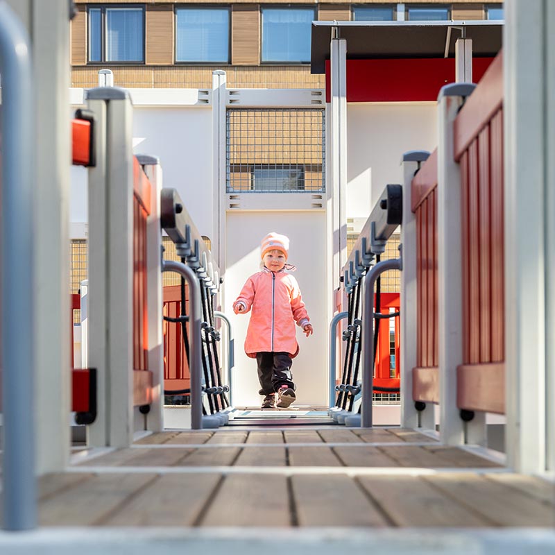 Pieni tyttö kävelee ja harjoittaa tasapainoaan