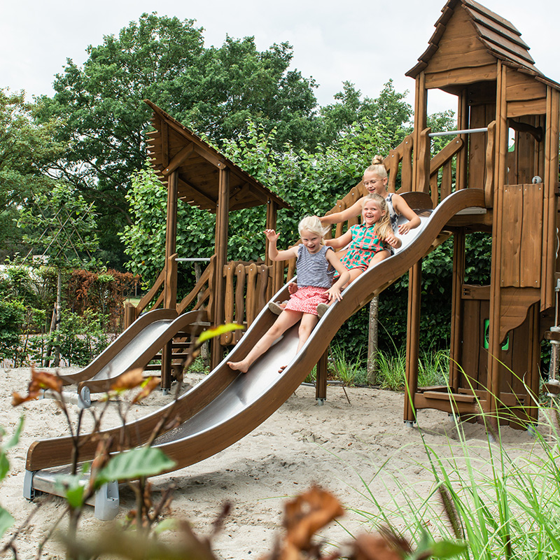 Children on a slide on a Flora play product